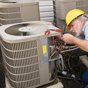 Technician assessing air conditioner lifespan and repair options on an AC in a Durham home
