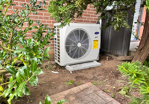 Aire One East technician at a cold-climate heat pump during a heat pump repair Durham Region service call