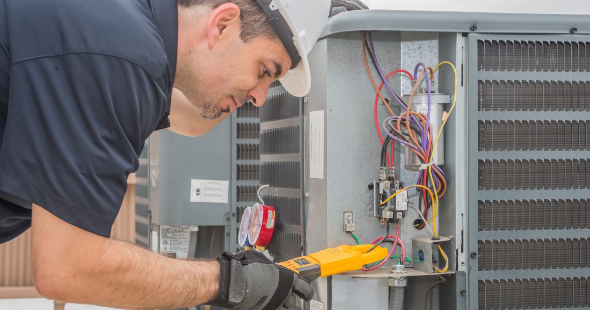 Heat pump maintenance check, cleaning and inspecting a unit in a Durham home