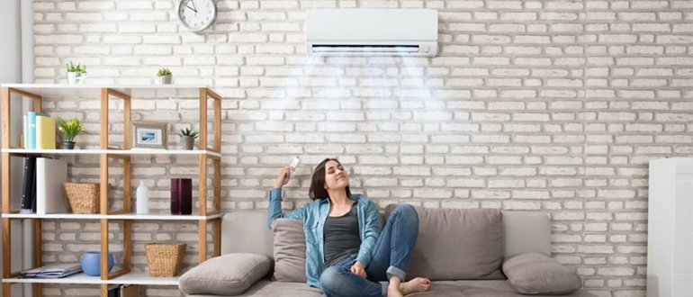 Central air conditioner condenser unit installed outside a home