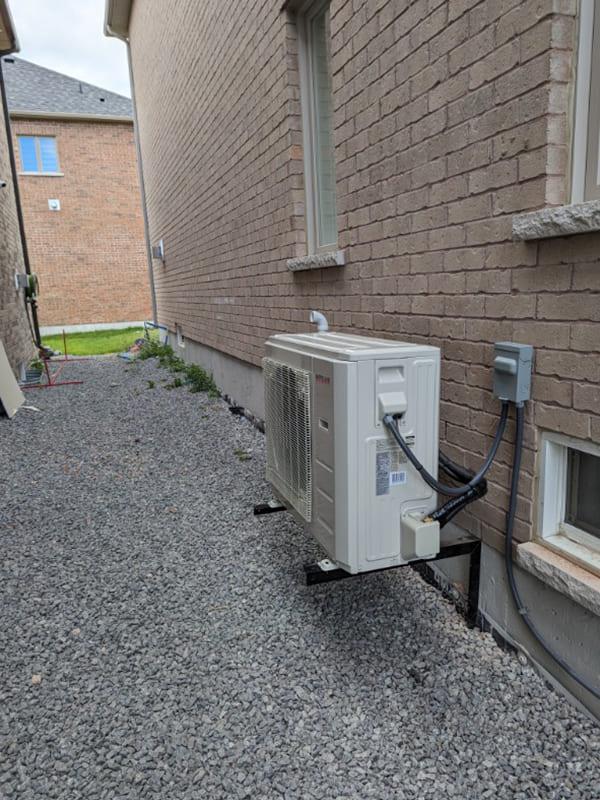 Aire One East technician performing an air duct cleaning inspection in a Durham Region home